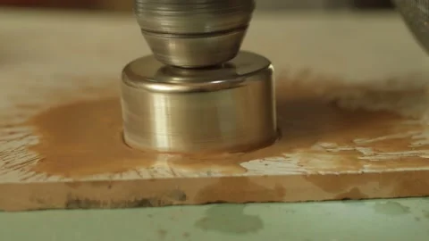 Diamond crown drill a hole in a ceramic tile, close-up Stock Footage 151321625