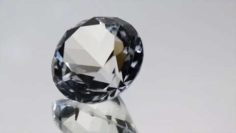 Diamond crystal rotating over grey background with reflection. Gemstone Stock Footage 318006509