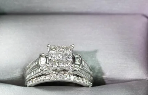 A diamond engagement ring in a box with glint/reflection. Shimmering princess Stock Photos