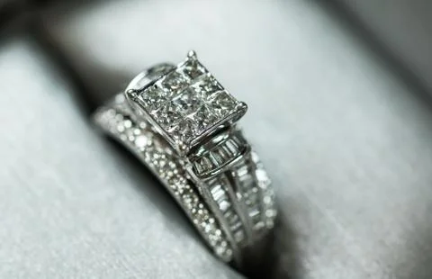 A diamond engagement ring in a box with glint/reflection. Shimmering princess Stock Photos