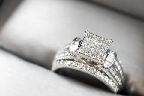 A diamond engagement ring in a box with glint/reflection. Shimmering princess Stock Photos