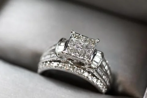 A diamond engagement ring in a box with glint/reflection. Shimmering princess Stock Photos