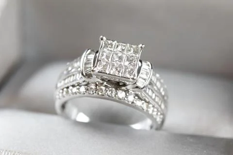 A diamond engagement ring in a box with glint/reflection. Shimmering princess Stock Photos