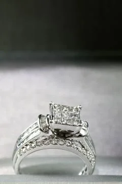 A diamond engagement ring in a box with glint/reflection. Shimmering princess Stock Photos