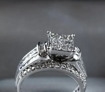 A diamond engagement ring in a box with glint/reflection. Shimmering princess Stock Photos