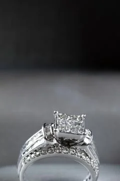 A diamond engagement ring in a box with glint/reflection. Shimmering princess Stock Photos