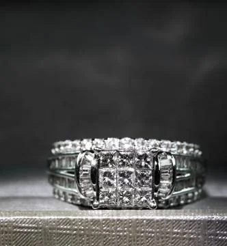 A diamond engagement ring in a box with glint/reflection. Shimmering princess Stock Photos