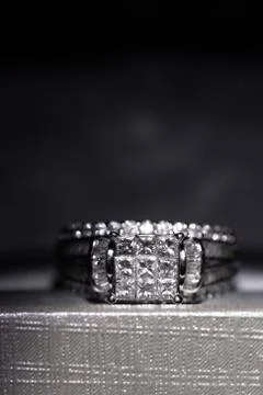 A diamond engagement ring in a box with glint/reflection. Shimmering princess Stock Photos