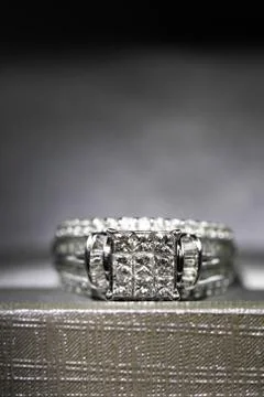 A diamond engagement ring in a box with glint/reflection. Shimmering princess Stock Photos