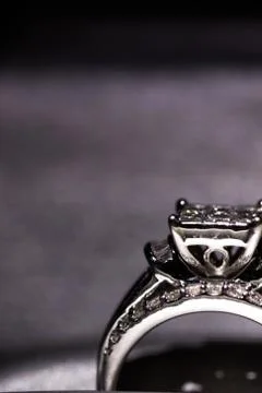 A diamond engagement ring in a box with glint/reflection. Shimmering princess Stock Photos