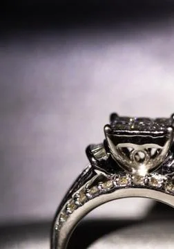 A diamond engagement ring in a box with glint/reflection. Shimmering princess Stock Photos