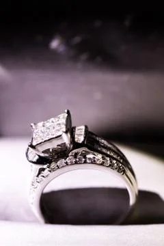 A diamond engagement ring in a box with glint/reflection. Shimmering princess Stock Photos