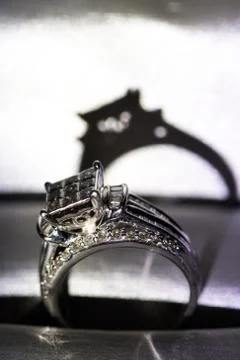 A diamond engagement ring in a box with glint/reflection. Shimmering princess Stock Photos