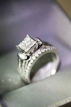 A diamond engagement ring in a box with glint/reflection. Shimmering princess Stock Photos