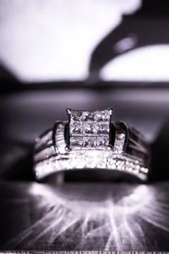 A diamond engagement ring in a box with glint/reflection. Shimmering princess Stock Photos