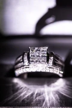 A diamond engagement ring in a box with glint/reflection. Shimmering princess Stock Photos