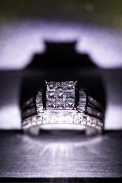 A diamond engagement ring in a box with glint/reflection. Shimmering princess Stock Photos