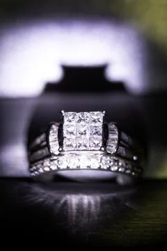 A diamond engagement ring in a box with glint/reflection. Shimmering princess Stock Photos