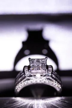 A diamond engagement ring in a box with glint/reflection. Shimmering princess Stock Photos