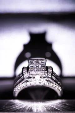 A diamond engagement ring in a box with glint/reflection. Shimmering princess Stock Photos