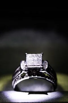 A diamond engagement ring in a box with glint/reflection. Shimmering princess Stock Photos