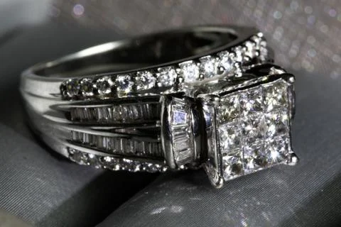 A diamond engagement ring in a box with glint/reflection. Shimmering princess Stock Photos