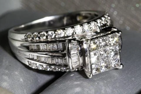 A diamond engagement ring in a box with glint/reflection. Shimmering princess Stock Photos