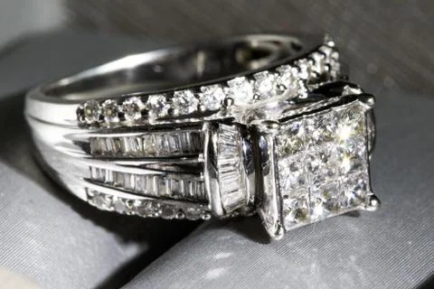 A diamond engagement ring in a box with glint/reflection. Shimmering princess Stock Photos