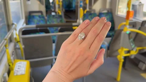 Diamond engagement ring displayed on hand inside bus landscape video. Stock Footage 315282456