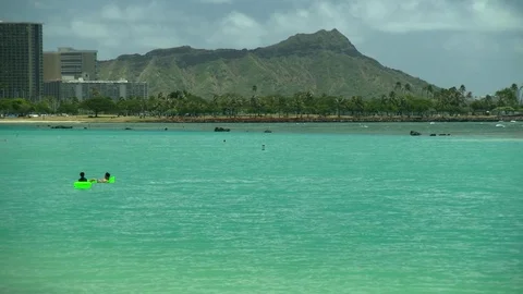 Diamond Head with two tourists floating on Ocean zoom out Stock-Footage 81524120