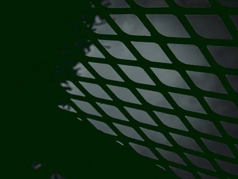 Diamond Mesh Metal Pattern with Backlit Green Glow, Abstract Industrial Textu Stock Photos