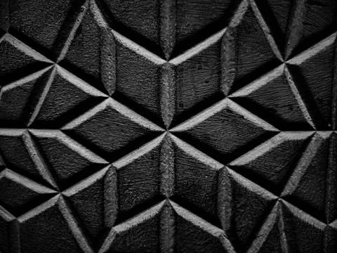 A diamond-patterned wall showcases a textured design in black and white. Stock Photos