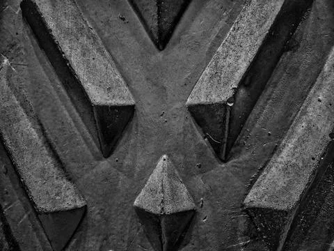 A diamond-patterned wall showcases a textured design in black and white. Stock Photos
