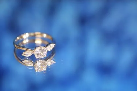 Diamond  ring on blue  background Stock Photos