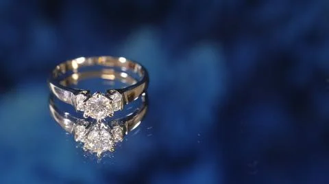 Diamond  ring on blue  background Stock Photos