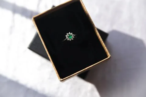 Diamond ring with emerald stone Stock Photos