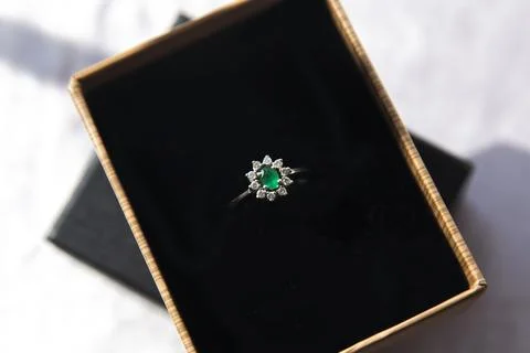 Diamond ring with emerald stone Stock Photos