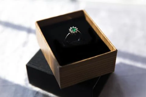 Diamond ring with emerald stone Stock Photos