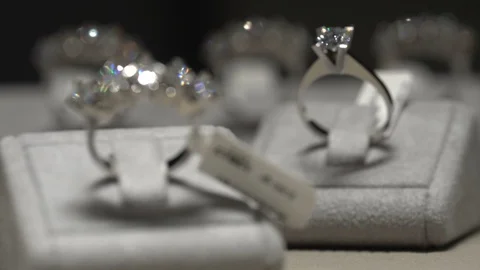 Diamond ring on the table in jeweler shop. Shine diamond solitaire ring Stock Footage