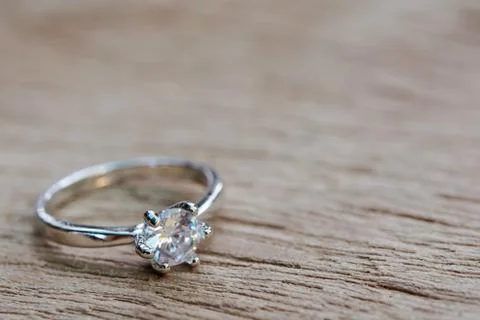 Diamond ring, wedding ring on plank wooden with copy space . Stock Photos