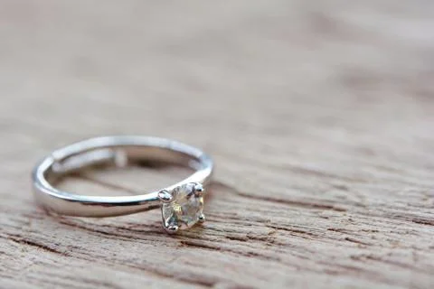 Diamond ring, wedding ring on plank wooden with copy space . Stock Photos