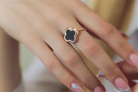 Diamond ruby ring on young model. Black dress and necklace. Stock Photos