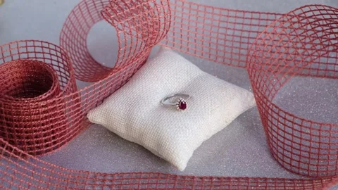 Diamond ruby white gold heart ring on white glittery background Stock Footage 297635946