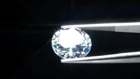 Diamond selective focus held in metal jeweller tweezers, brilliant stone cut  Video stock 162621810