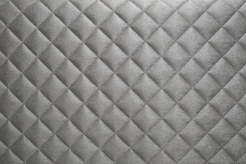 Diamond shape pattern on a velvet gray sofa, soft focus close up, abstract .. Stock Photos