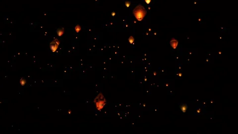 Diamond shaped flying lanterns fly in the dark sky Stock Footage 135767793