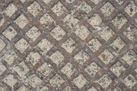 Diamond-shaped pattern of rusty metal surface. Stock Photos