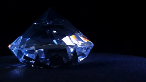 Diamond shining and rolling on a black cloth. Stock Footage 89558342