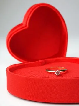 Diamond solitaire ring in heart-shaped box Stock Photos