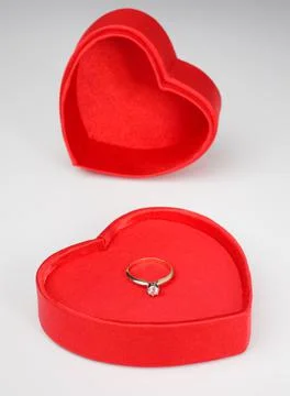 Diamond solitaire ring in red heart-shaped box Stock Photos